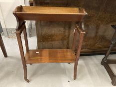 Edwardian mahogany book trolley with acanthus inlay squared supports terminating in brass castors.