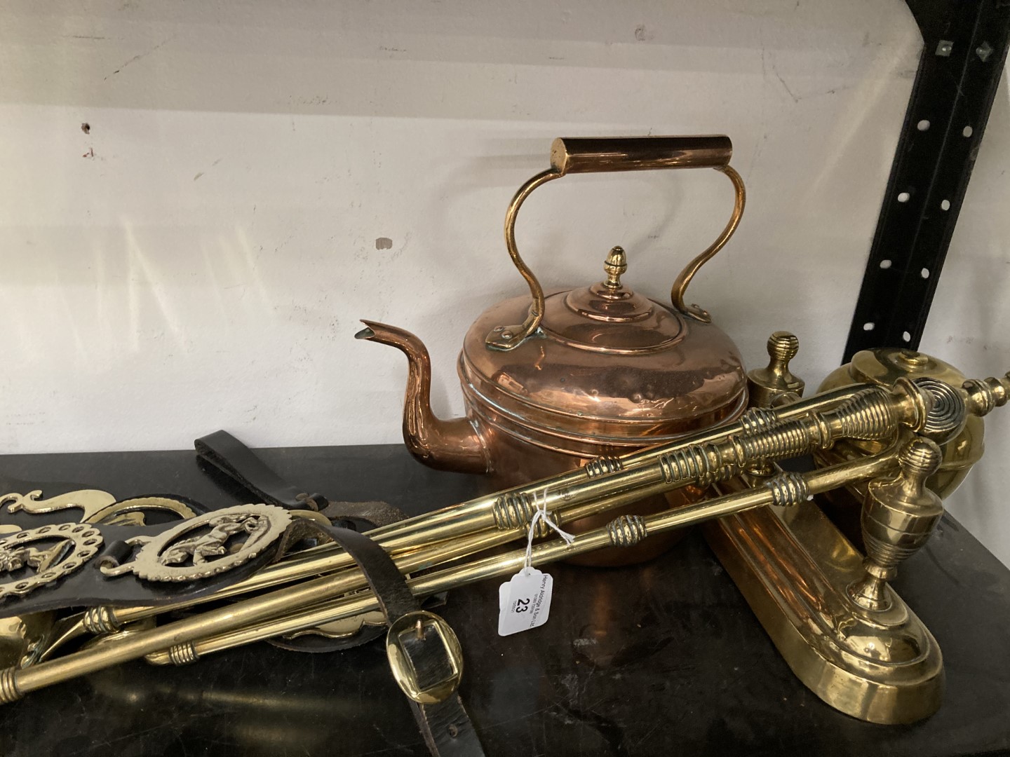 20th cent. Metalware: Brass companion set, tea caddy, horse brasses and copper kettle.