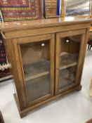 19th cent. Oak bookcase, glazed doors on bracket base. 31ins. x 15ins. x 43ins.