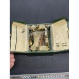 Ladies travelling vanity case in green leather, containing two powder compacts, one nail buff, and a