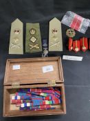 Militaria: Assorted badges, buttons, rank slides, medal ribbons, ribbon bars, medallions, and