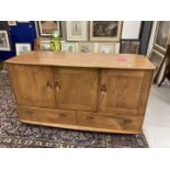20th cent. Ercol style Windsor oak sideboard. Three cupboards over two drawers with two cutlery