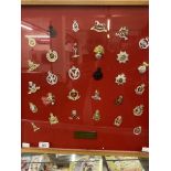 Militaria: Framed and glazed display case of thirty British Army cap badges presented 'To Maj Gen