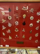 Militaria: Framed and glazed display case of thirty British Army cap badges presented 'To Maj Gen