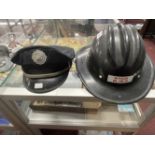 United States Fire Helmet Marked WYSOY Vol Fire Co. Plus a Brook Park Fire Dept. peaked cap. (2)