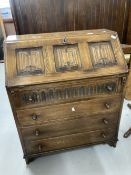 20th cent. Oak bureau with carved linen fold panels to top and carved decoration to top drawer