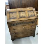 20th cent. Oak bureau with carved linen fold panels to top and carved decoration to top drawer