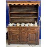 18th cent. Welsh oak/elm dresser with ornate fruit wood frieze to shelves. Base with two long