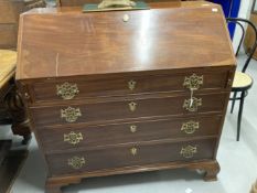 Early 19th cent. Mahogany bureau, four drawers below with brass furniture, on bracket supports.