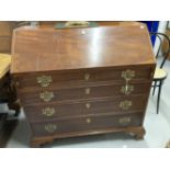 Early 19th cent. Mahogany bureau, four drawers below with brass furniture, on bracket supports.