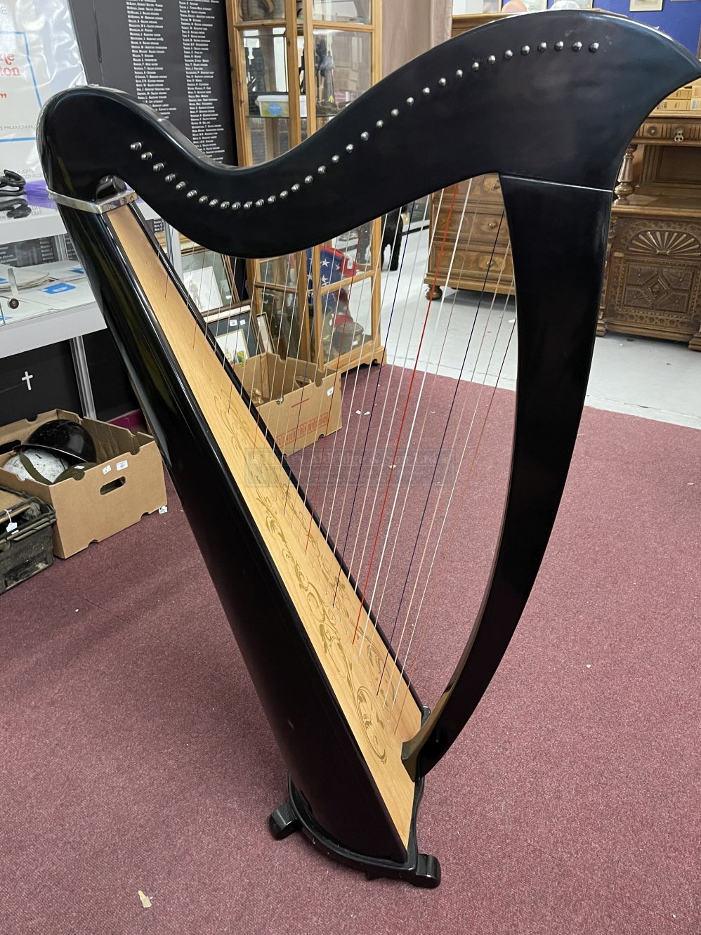Musical Instruments: Thirty four string Celtic harp, finished in black lacquer with decorated