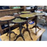 20th cent. Circular wine tables, some with leather inserts. (6)