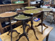 20th cent. Circular wine tables, some with leather inserts. (6)