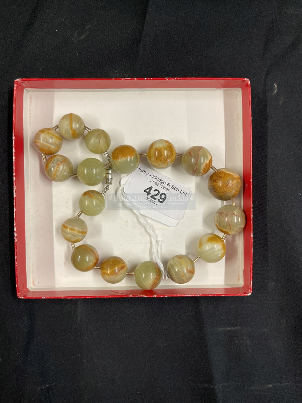 Jewellery: Jade circular beads (17) brown/green 20mm to 15mm. Length 14ins.