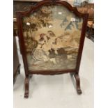 20th cent. Woolwork fire screen in ornate rosewood frame.