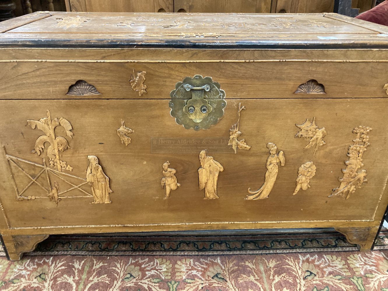 20th cent. Chinese camphor wood marriage chest decorated with stylised figures. 42ins. x 22ins.