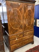 19th cent. Flame mahogany linen press two opening inlaid doors revealing five slides, two over three