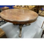 Late 19th cent. Mahogany oval tilt top loo table on ornate heavy three legged base with castors (