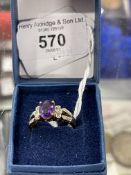 Hallmarked Jewellery: 9ct gold ring set with an oval amethyst, estimated weight 2.5ct, and twelve
