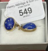 Jewellery: Yellow metal, pendant ring set with an oval cabouchon cut lapis lazuli, a 15¾ins trace