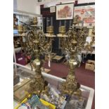 20th cent. Ornate brass candle garniture of five nozzles over decorative bases with rampant lion