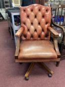 20th cent. Tan leather button back office swivel chair.