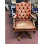 20th cent. Tan leather button back office swivel chair.