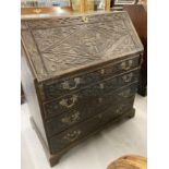 18th cent. Oak bureau with later carved decoration. Fully fitted interior, the centre compartment