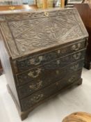 18th cent. Oak bureau with later carved decoration. Fully fitted interior, the centre compartment