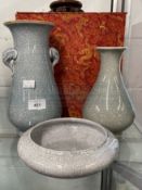 20th cent. Chinese monochrome crackle glaze items, two vases and a bowl in a silk covered box. (3)