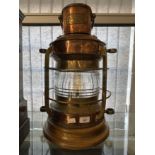 Maritime: 20th cent. Brass and copper starboard lantern on oak base, maker's plate Nunn and Ridsdale