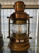 Maritime: 20th cent. Brass and copper starboard lantern on oak base, maker's plate Nunn and Ridsdale