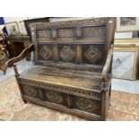 20th cent. Oak monks bench, matching carved panels. 47ins. x 42ins. x 22ins.
