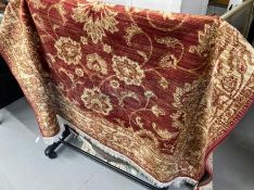 21st cent. Madder red ground rug with gold stylised floral decoration. 75ins. x 52ins.