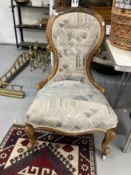 Victorian mahogany spoon back nursing chair upholstered in tapestry fabric.