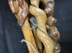 Walking sticks, one with carved Indian head, one with six faces, one carved monkey top, one with