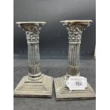 Silver Corinthian column candlesticks with detachable nozzles, the columns raised on stepped