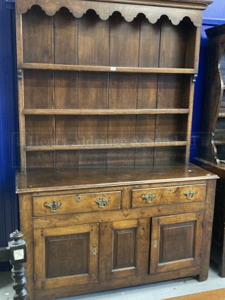 19th cent. Rustic oak dresser, open rack above two drawers and two cupboards. 57½ins. x 85ins. x
