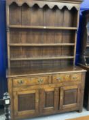 19th cent. Rustic oak dresser, open rack above two drawers and two cupboards. 57½ins. x 85ins. x