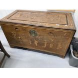 20th cent. Chinese camphor wood marriage chest decorated with stylised figures. 42ins. x 22ins.