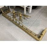 19th cent. Oversized brass fender, fire dogs and tools. 62ins.