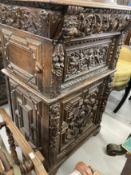 20th cent. Flemish heavily carved cupboard decorated with cherubs and geometric motifs. 77ins. x