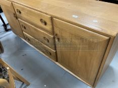 Vintage Design: Ercol elm sideboard, cupboard to each side with three drawers to the centre, with