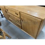 Vintage Design: Ercol elm sideboard, cupboard to each side with three drawers to the centre, with