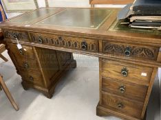 20th cent. Oak pedestal desk with green leather skiver and carved leaf decoration. 32ins. x 24ins. x