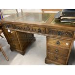 20th cent. Oak pedestal desk with green leather skiver and carved leaf decoration. 32ins. x 24ins. x