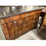 Empire mahogany and ormolu mounted commode, the grey marble top above four long drawers on shaped