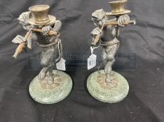 Decorative lead figures of Pan on green marble bases, converted to candlesticks, a pair. 9½ins.