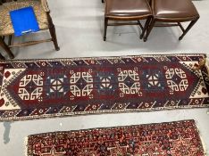 Carpets/Rugs: 20th cent. Runner, geometric pattern on a maroon background. 102ins. x 28ins.