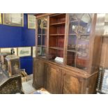 Late George III mahogany library bookcase, the moulded cornice above three glazed doors with